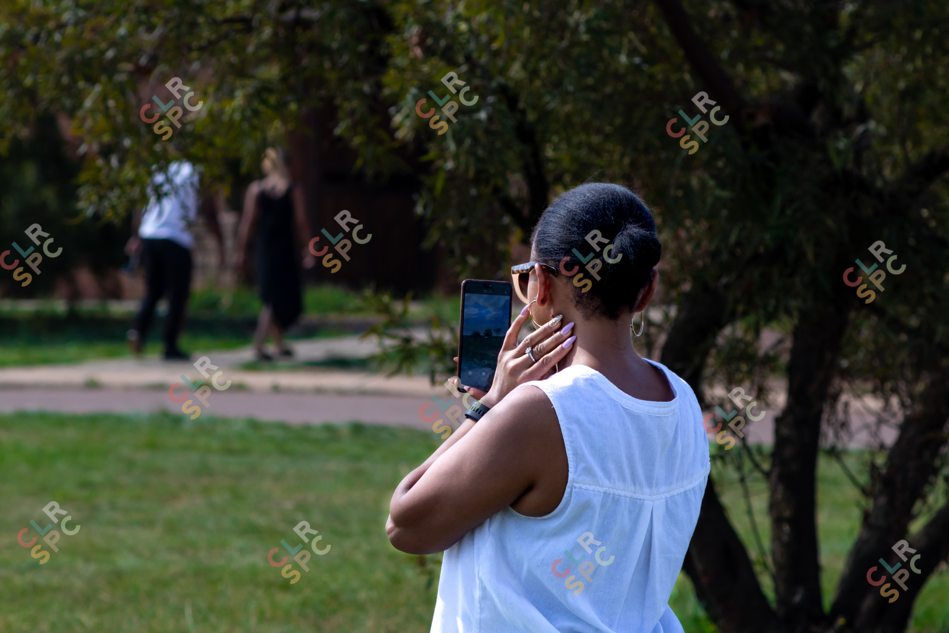 Lady wearing white on a sunny day  taking a selfie