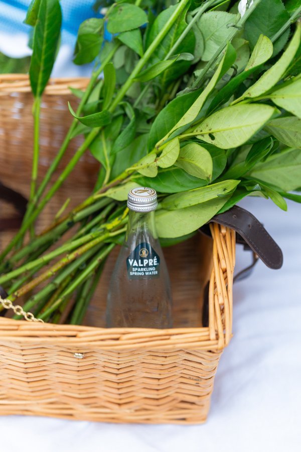 Valpre bottles with flowers in a basket
